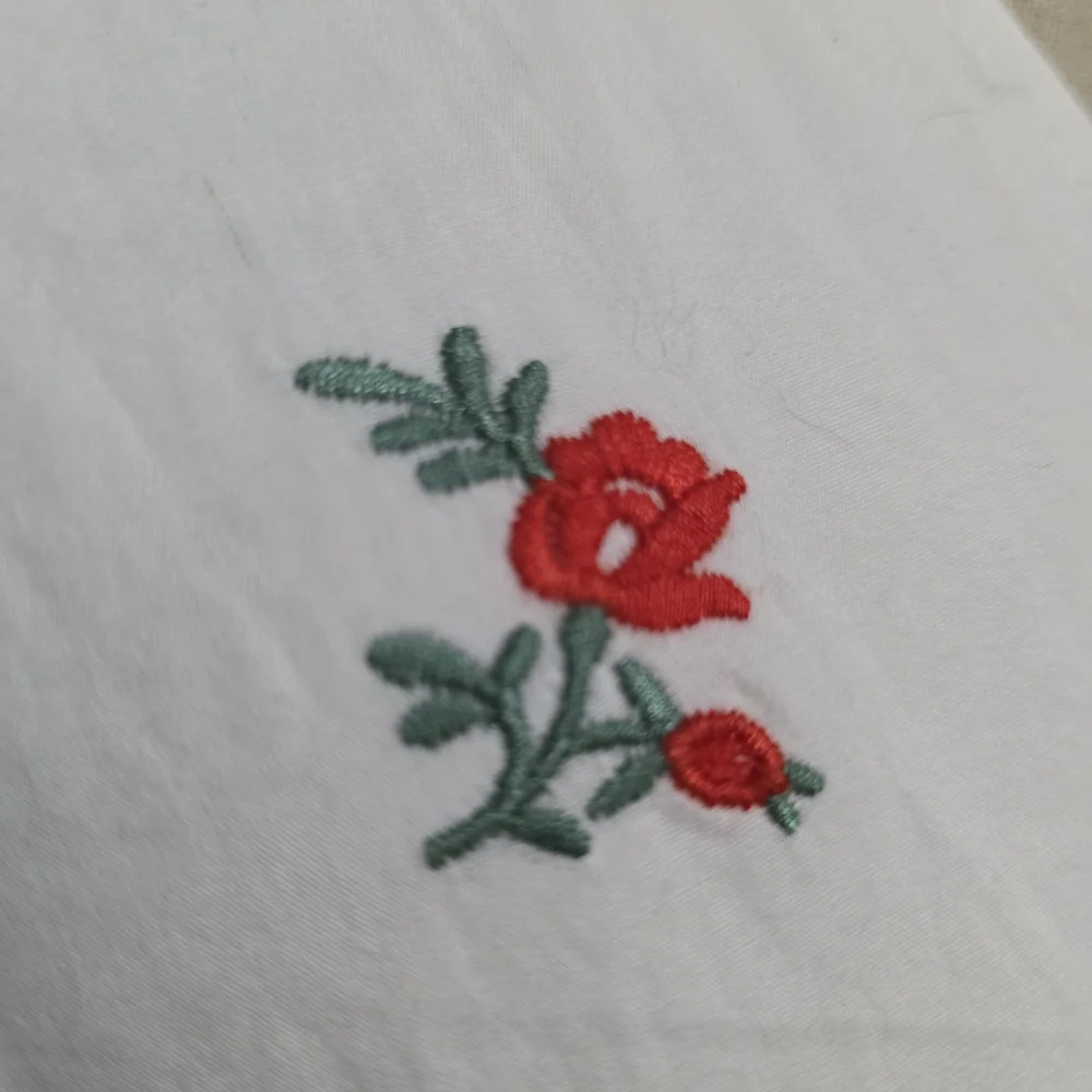 Anthropologie Maeve Embroidered White Floral Wrap Blouse with Red Rose